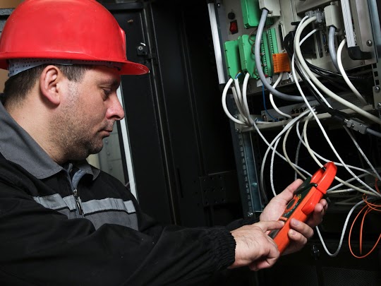 An electrician performing a yearly inspection